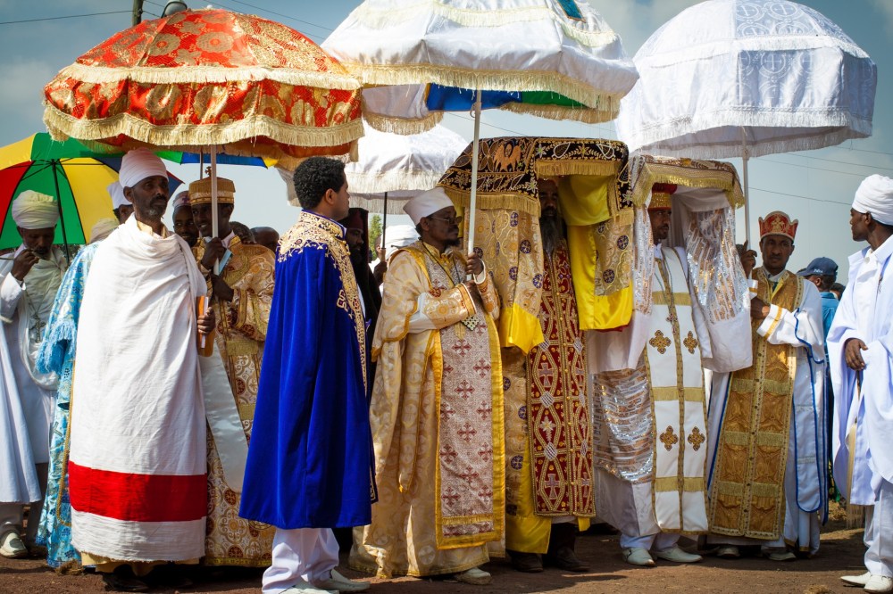 Ethiopian Indiana Jones carrying replicas of the Ark.